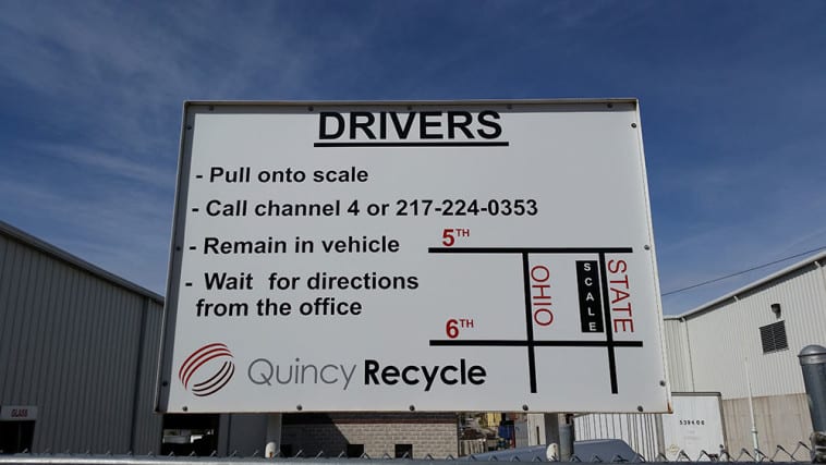 Exterior view of a Quincy Recycle facility with various signage to help direct drivers arriving to the facility.