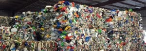 Large bales of multi-color commingled plastic material.