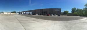 Large brown building with shipping and receiving docks at Quincy Recycle location in Chicago, IL
