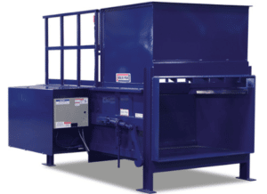 Large blue compactor used for processing recycled materials.