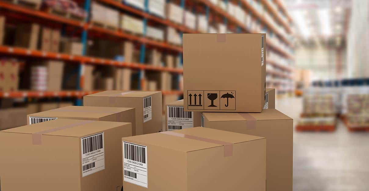 Stack of brown cardboard boxes inside of a warehouse.