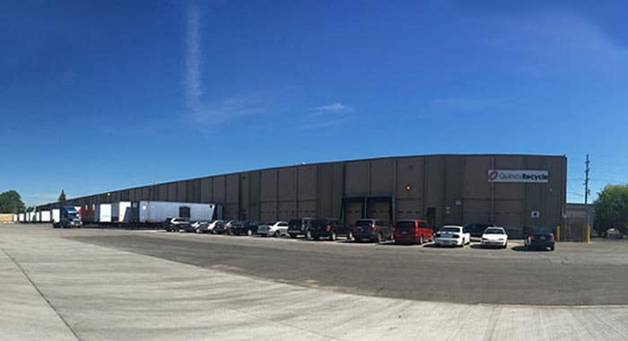 Large brown building with shipping and receiving docks at Quincy Recycle location in Chicago, IL