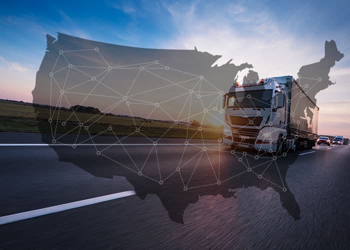 About us: Transparent map of the US on top of a tractor trailer driving on a highway.