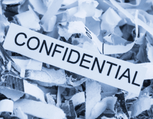 shredded papers with 'confidential' written on them